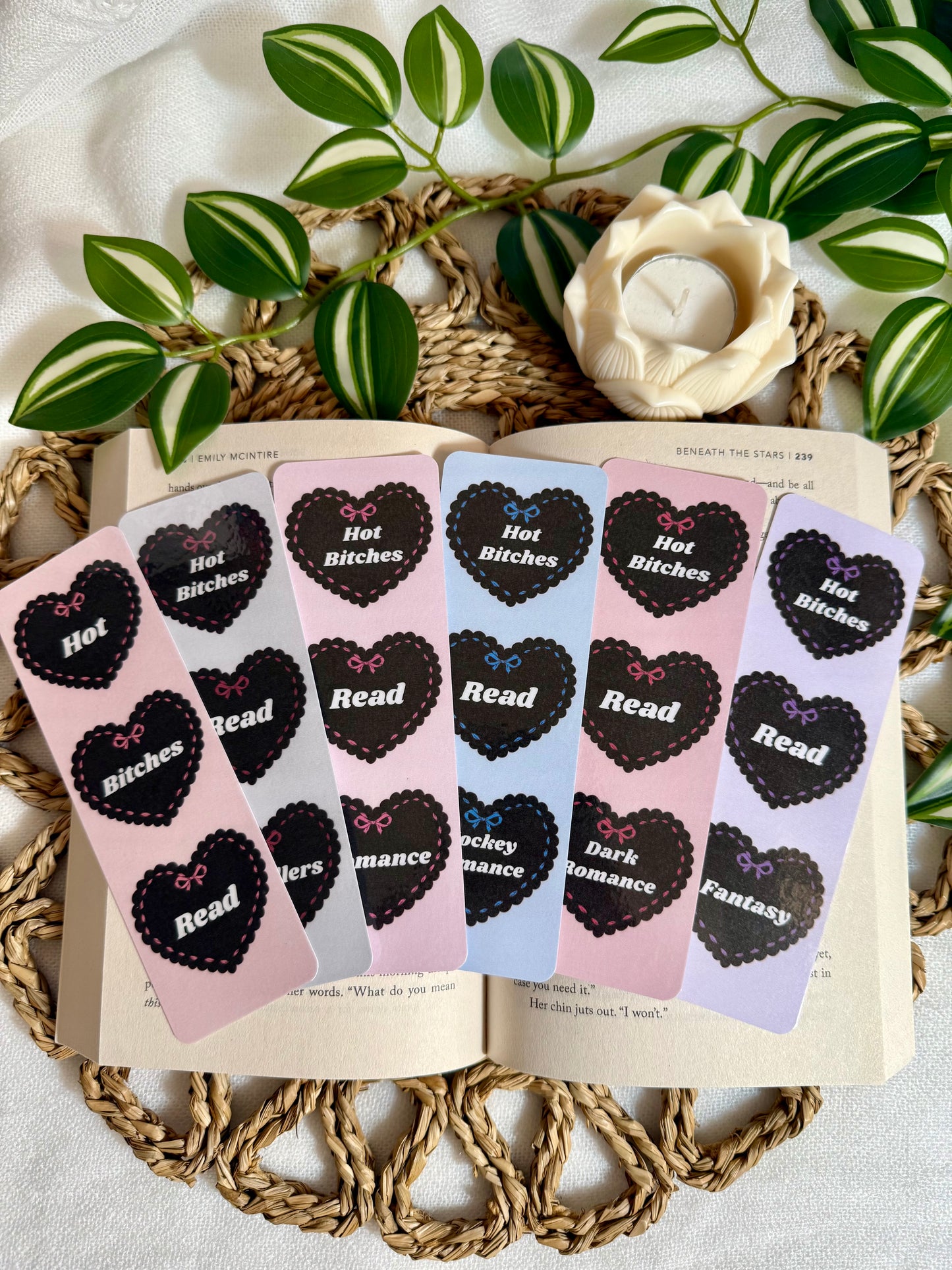 Set of bookmarks with heart designs and text saying Hot Bitches Read n a book page, surrounded by decorative elements.