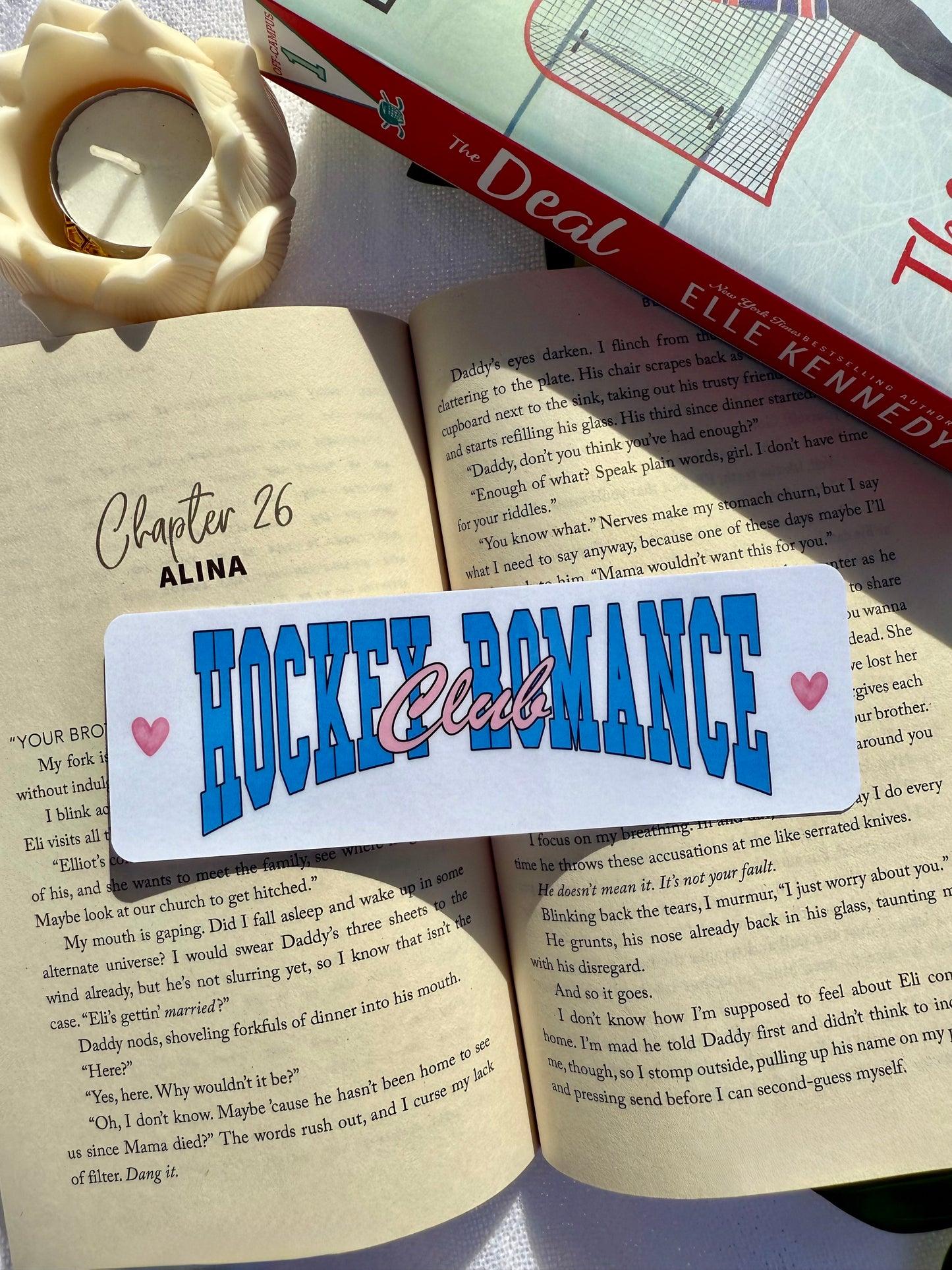 Bookmark with 'Hockey Romance' text on an open book