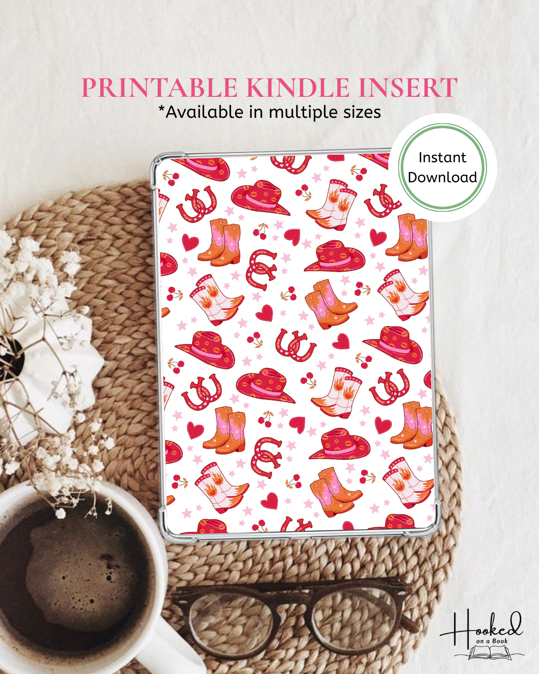 Kindle cover with a pink and white cowboy pattern of hats, books and horseshoes on a white surface with coffee and glasses.