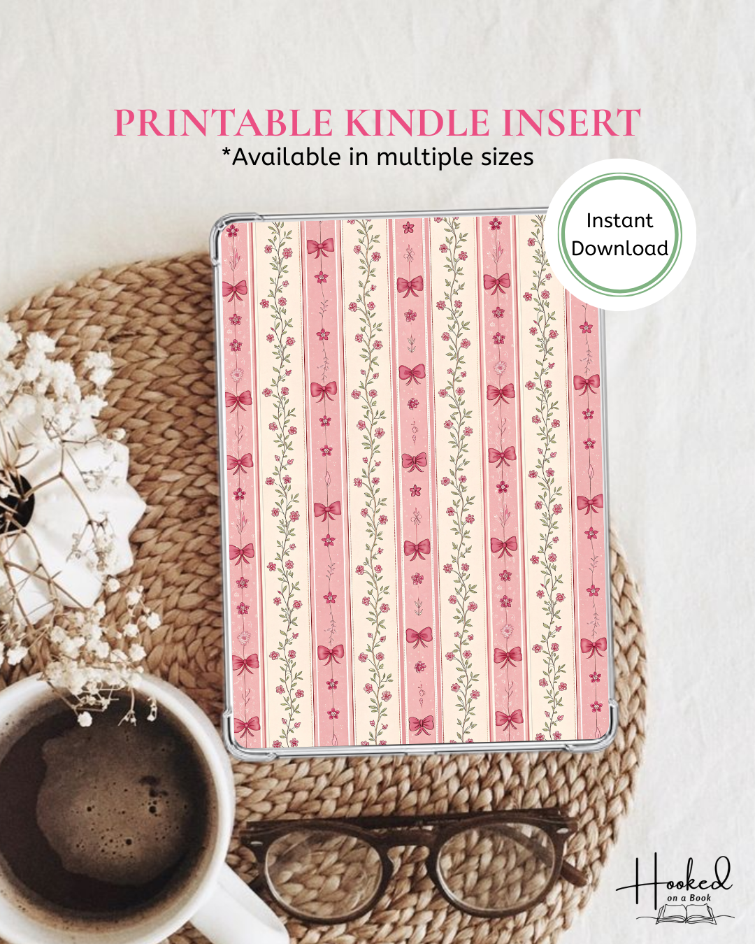 Kindle insert with pink striped pattern of flowers and bows on a white surface with coffee and glasses.