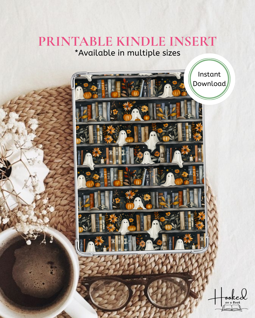 Kindle cover with Halloween design featuring books, ghosts, and pumpkins on a woven surface with a cup of coffee and glasses.