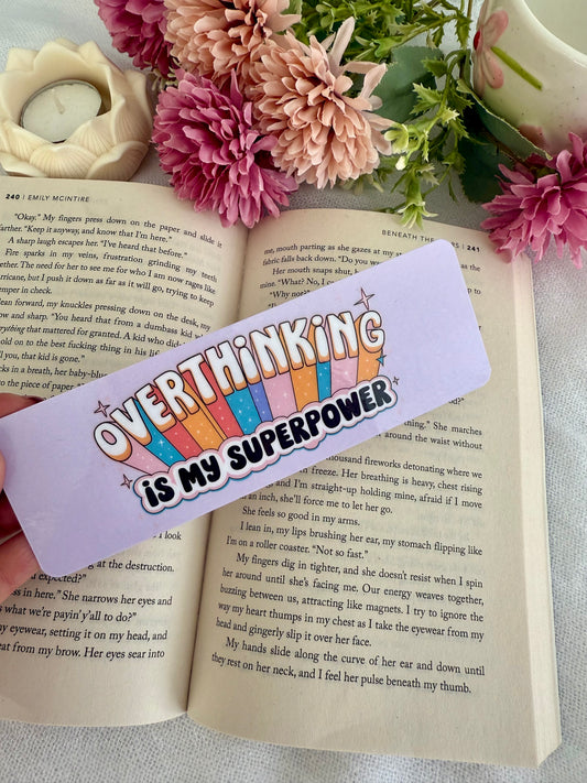 Bookmark with 'Overthinking is my superpower' text on an open book with flowers.