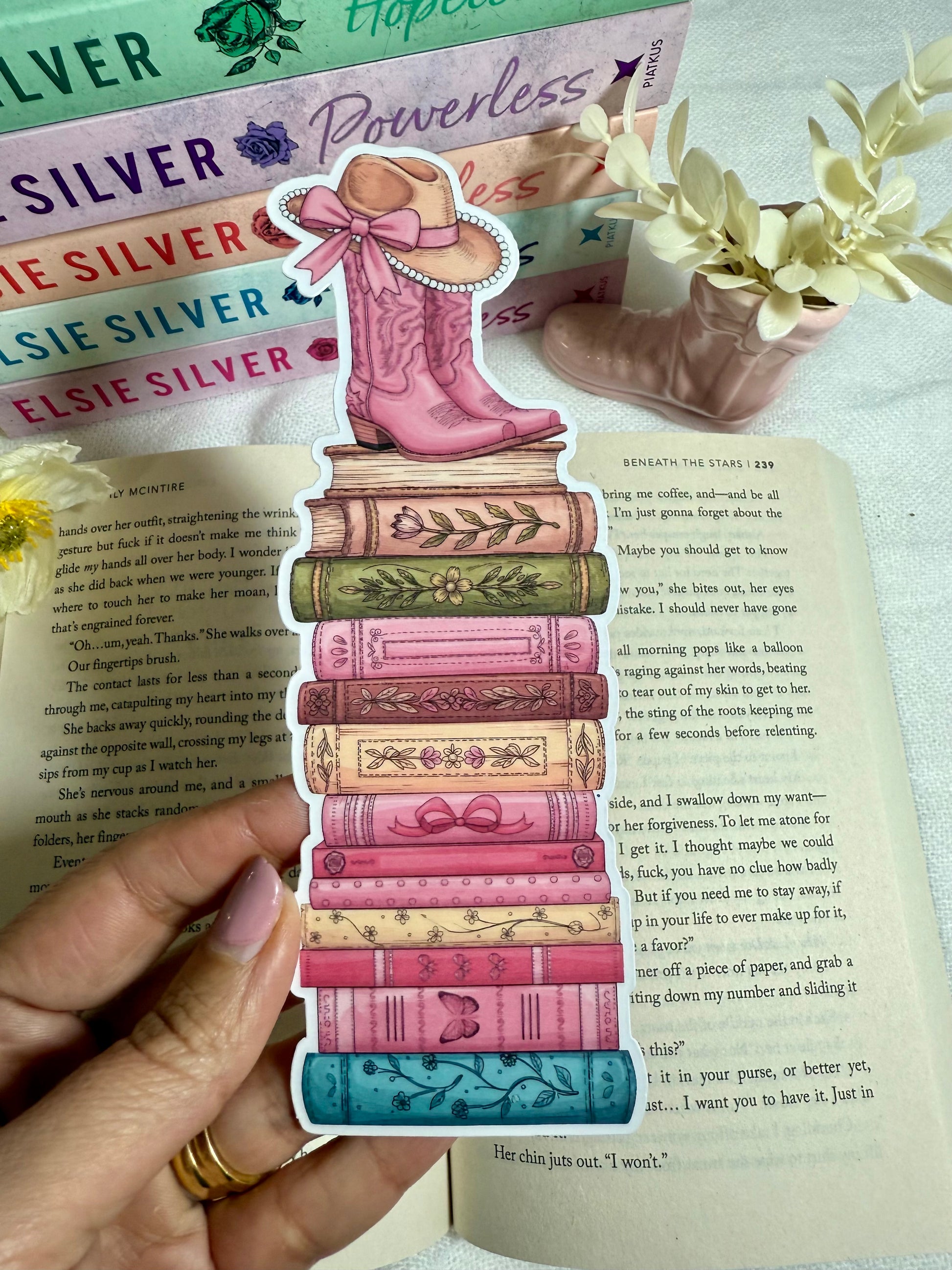 Colorful book-shaped bookmark with pink cowboy boot design on an open book