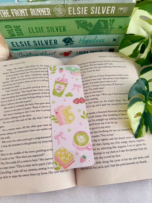 Bookmark with matcha and books design. Bookmark is placed on an open book.