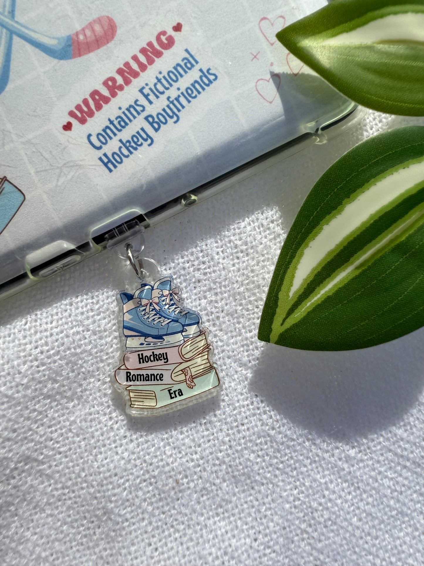 Book charm on a book with a leaf in the background