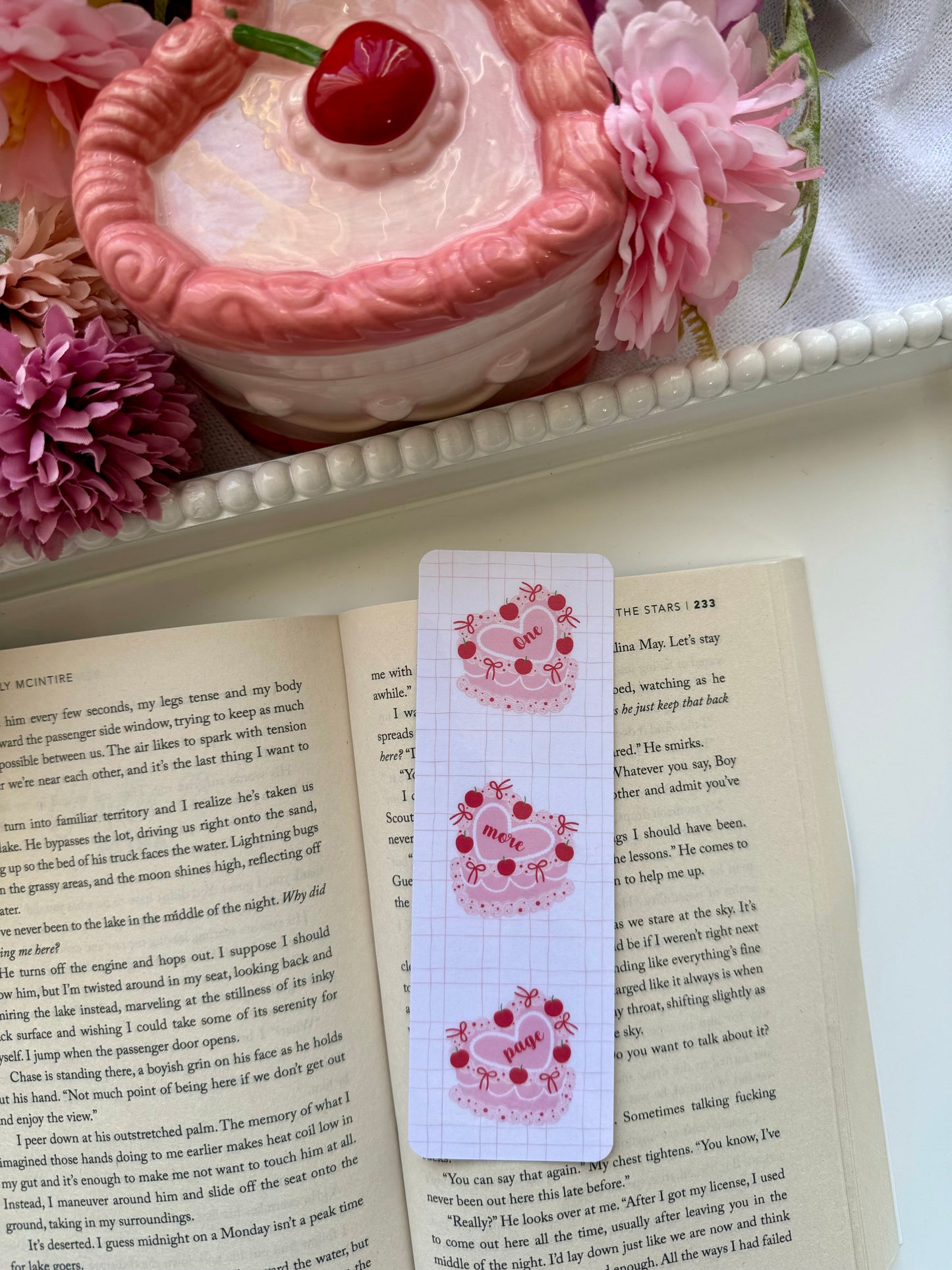 Coquette cake bookmark with the text One More Page